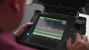 Can I DIY Bug Sweep? DIY Home Bug Sweeps and Why It's Not a Good Idea 3 a person operating spectrum analyser